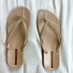 shimmery rose gold flip flops